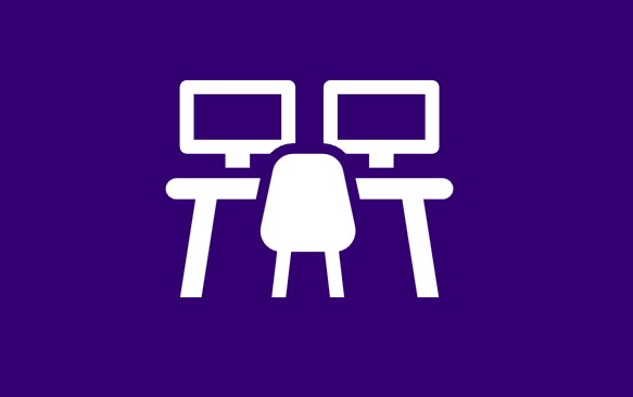 Clear a space on your desk.  You might want to pad the edge.  Turn the chair away from the desk (stable chair preferably) and move it far enough away for you to be able to stand fully upright